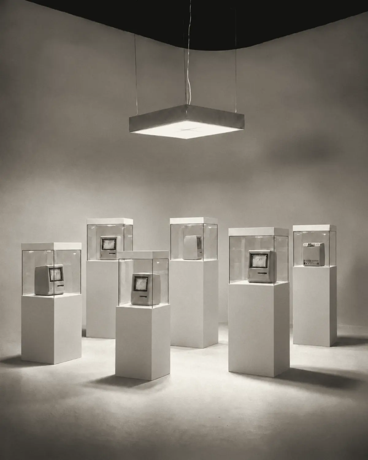Rendering of the exhibition: six early personal computers in glass vitrines under one square light