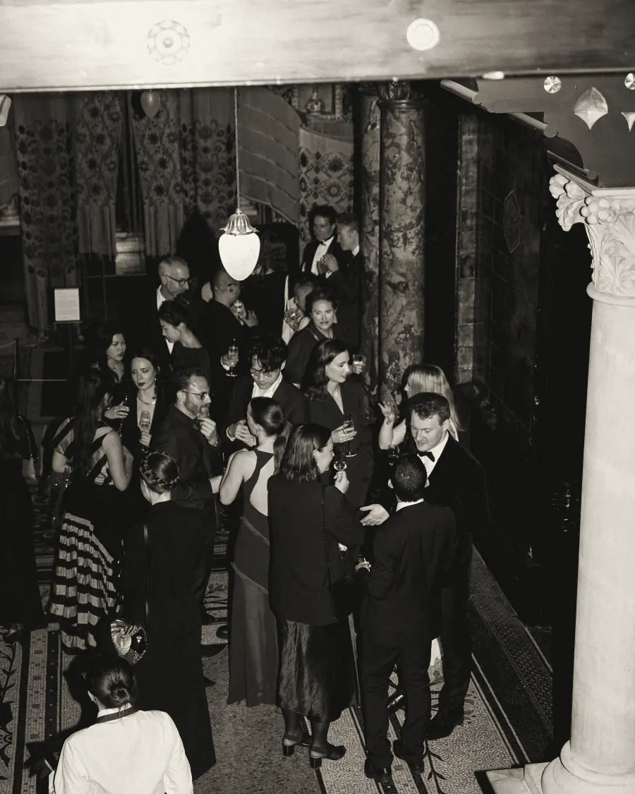 Guests in the tiled Arab Hall of Leighton House, seen from above