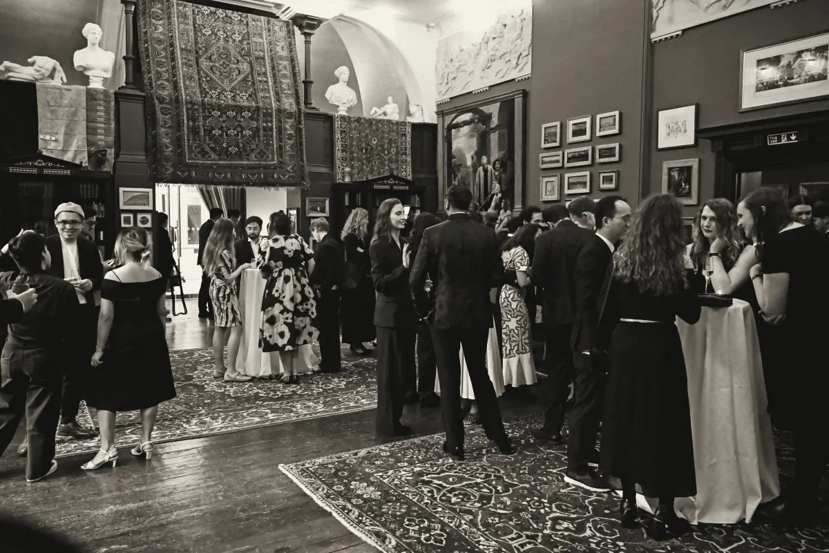 Guests in conversation in the painted halls of Leighton House, London
