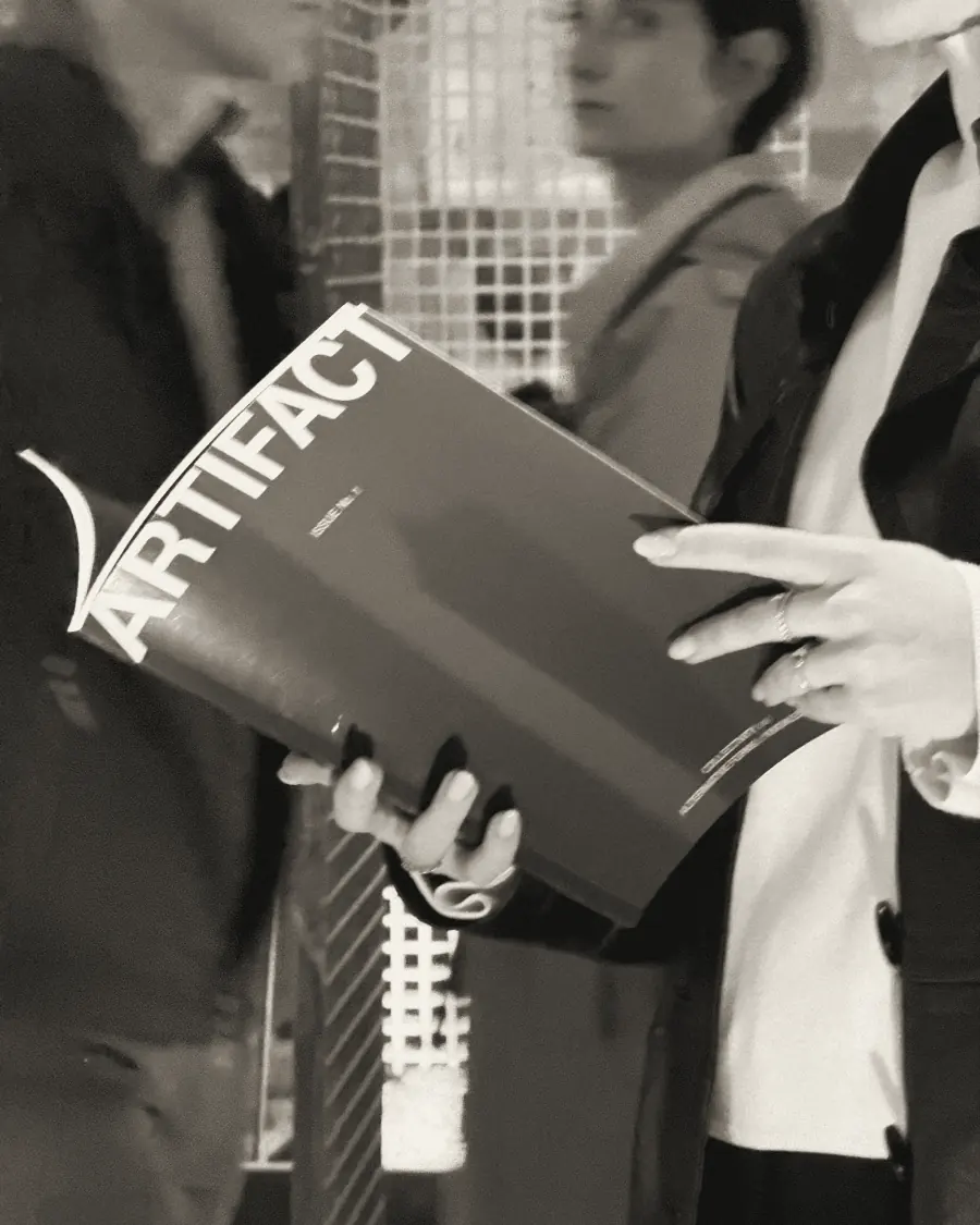 A visitor reading Issue No. 1 in Venice